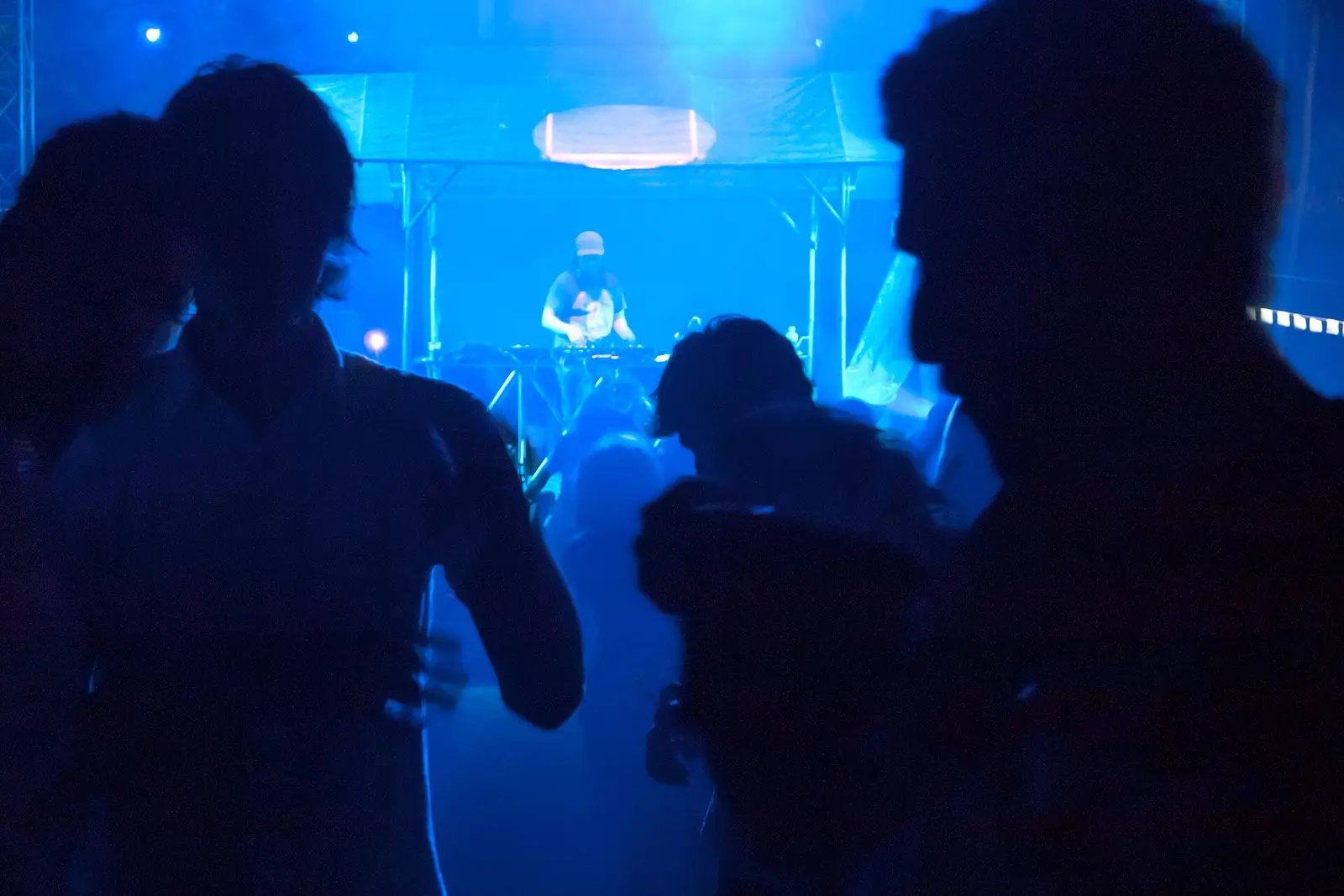 People dancing close together under blue party lights