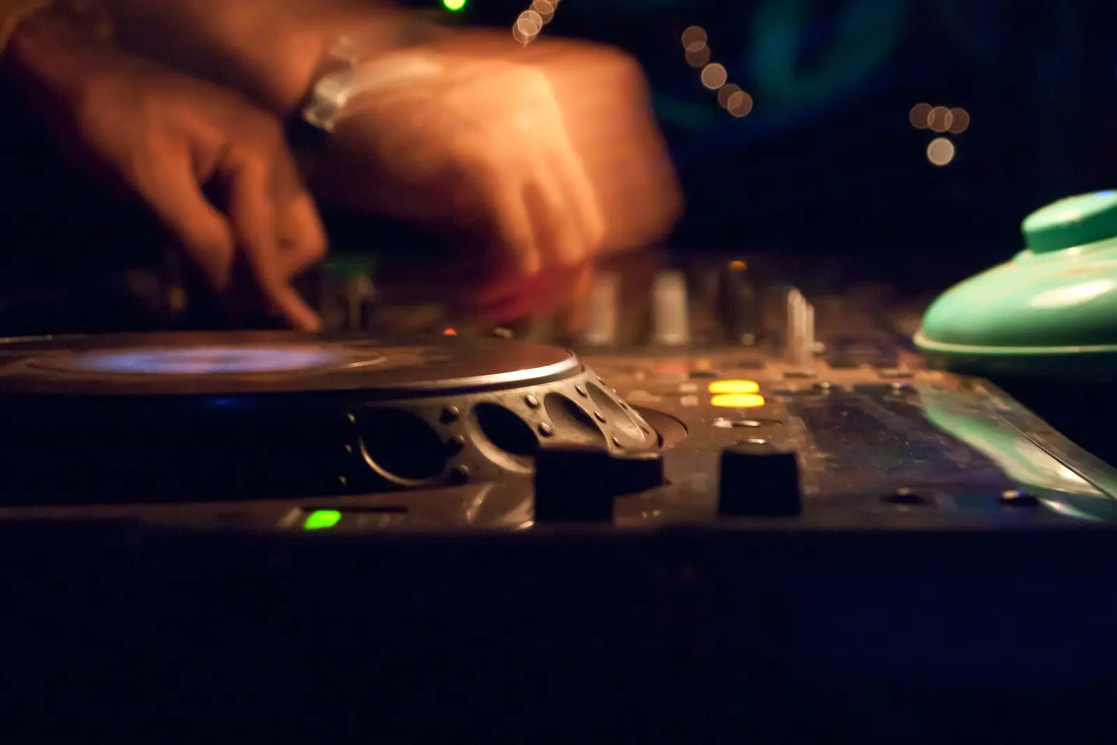 A DJ cueing a record on a turntable